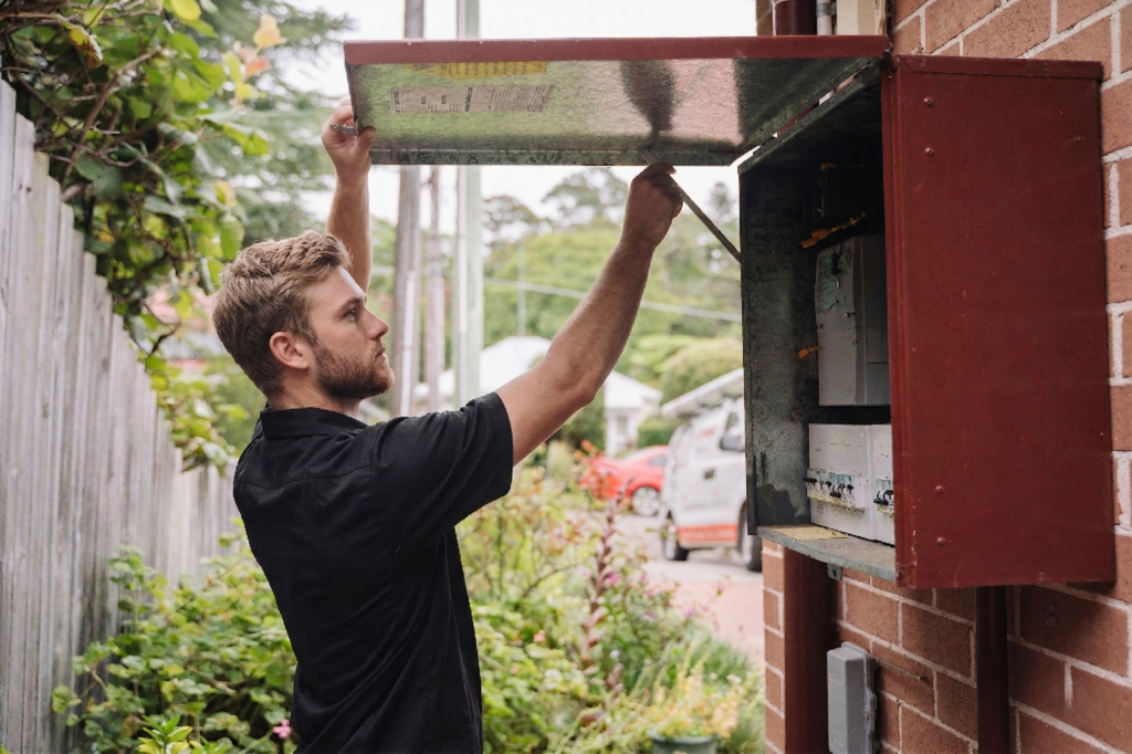 Electrician installing downlights in a Kogarah home